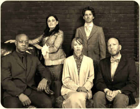 L-R: Charles Everrett (as Torvald Helmer), Natalie Menna (as his wife, Nora), Jane Cortney&nbsp;(as Mrs. Linde, Nora's childhood friend), Tom&nbsp;Paul Ryan&nbsp;(as Krogstad), Chris Hahn (as Doctor Rank, a close, trusted friend of the Helmers). Photo by Jonathan Slaff.